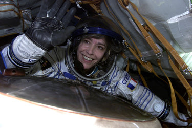 Claudie waves from inside the cramped Soyuz