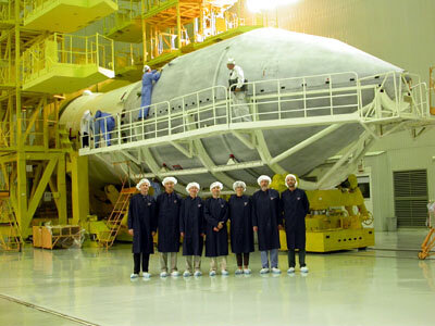 3.10.02.  ESA team members in front of the Proton fairing after  encapsulation