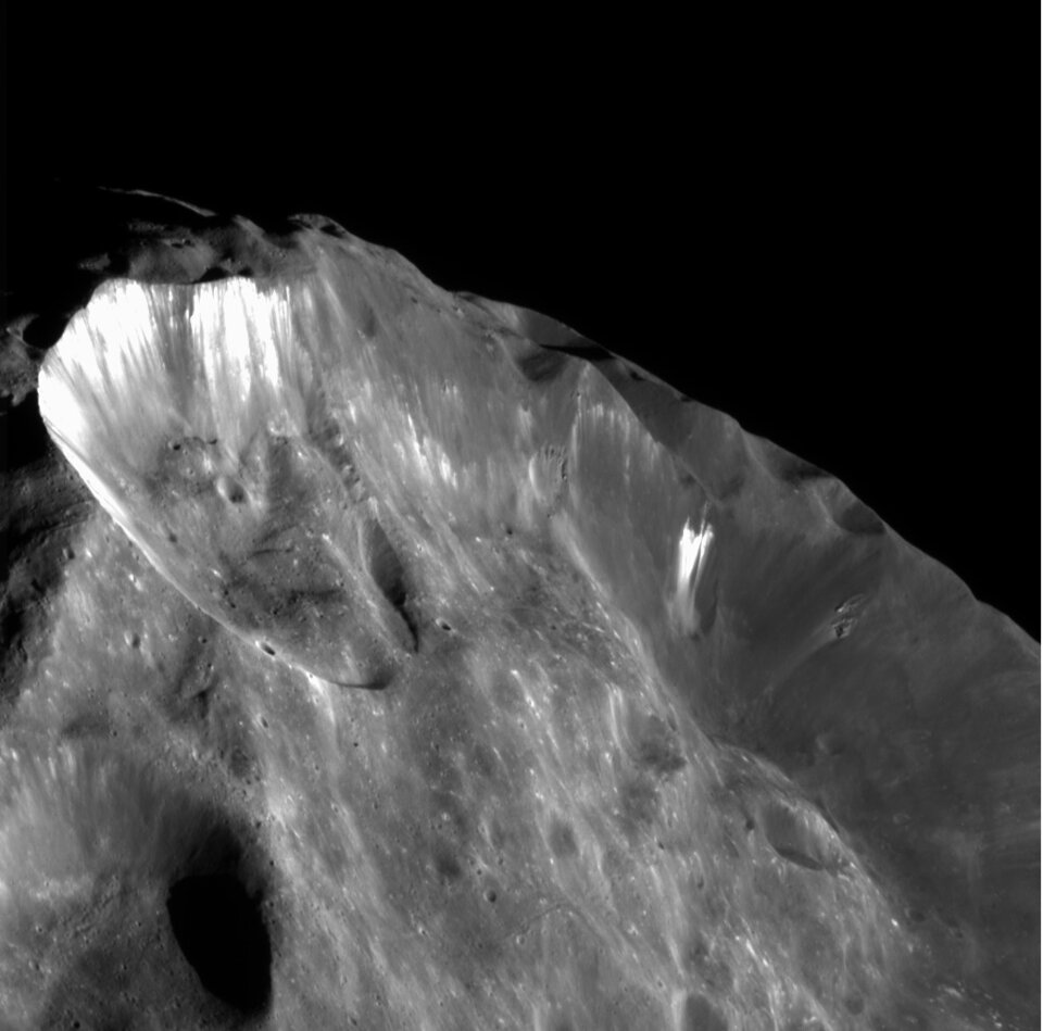 Ice revealed on Phoebe by subsidence of crater walls