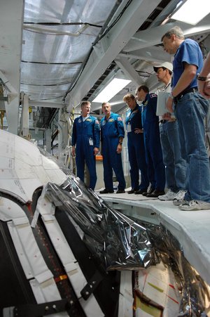 STS-115 crew members look over the cockpit on the orbiter Atlantis