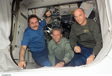 ISS Expedition 13 crew Pavel Vinogradov (left), Thomas Reiter and Jeff Williams wave to the departing STS-121 crew