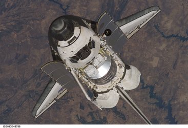 The Space Shuttle Discovery approaches the International Space Station for docking