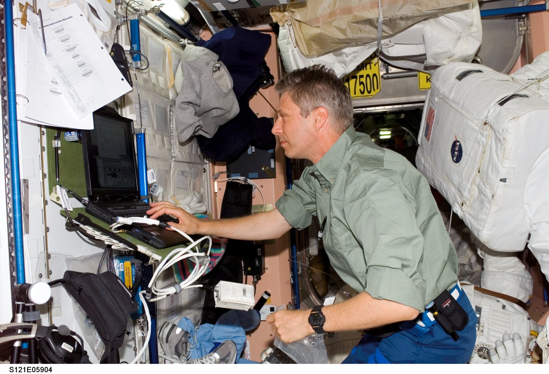 Thomas Reiter uses a computer in the Unity node of the International Space Station