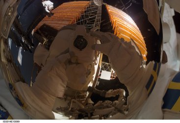 A reflection in Christer Fuglesang's helmet during the fourth STS-116 spacewalk