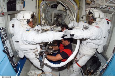 Christer Fuglesang and Robert Curbeam prepare for the first spacewalk