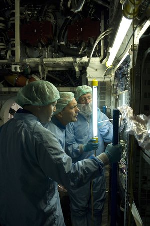 ESA astronaut Hans Schlegel inspects a payload rack inside the European Columbus laboratory