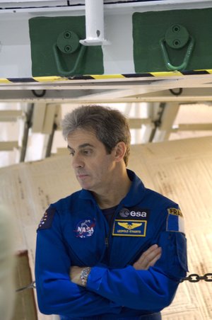 ESA astronaut Leopold Eyharts during an inspection of Space Shuttle Atlantis