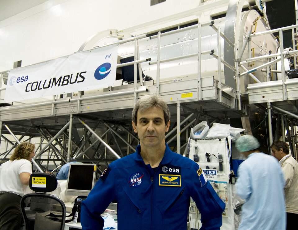 ESA astronaut Leopold Eyharts with the European Columbus laboratory in NASA's Space Station Processing Facility at KSC, Florida