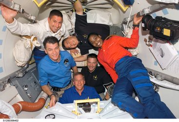 STS-120 crew members after hatch opening between ISS and Discovery