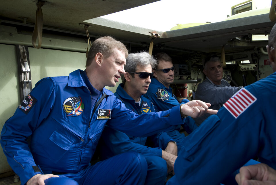STS-122 crew inside an emergency evacuation vehicle at Kennedy Space Center