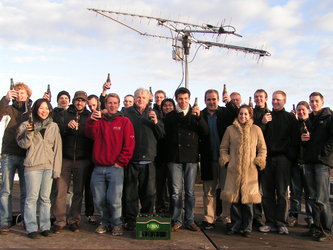 The GENSO team celebrates the successful demonstration next to the rotating antennas.