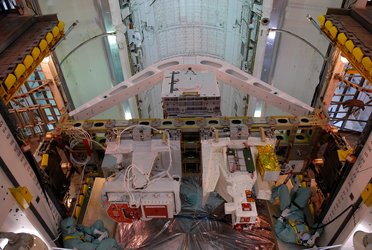 The integrated cargo carrier-lite is transferred to Space Shuttle Atlantis' payload bay