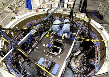 Batteries are placed inside the ATV's Equipped Avionics Bay before mating with the spacecraft's pressurised module