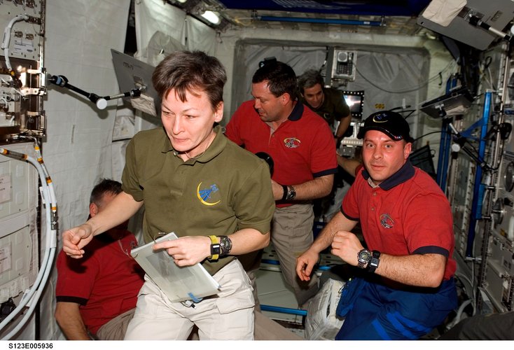 ISS and STS-123 crewmembers at work in Columbus