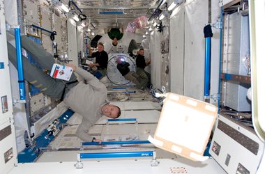 Astronauts work inside the newly installed Japanese Kibo laboratory