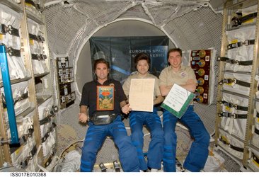 ISS Expedition crew displays the Jules Verne book and manuscripts