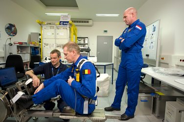 Frank De Winne and Andre Kuipers receive instruction in use of the Flywheel Exercise Device