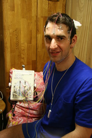 Oliver is fitted out with equipment to measure his nighttime brain activity