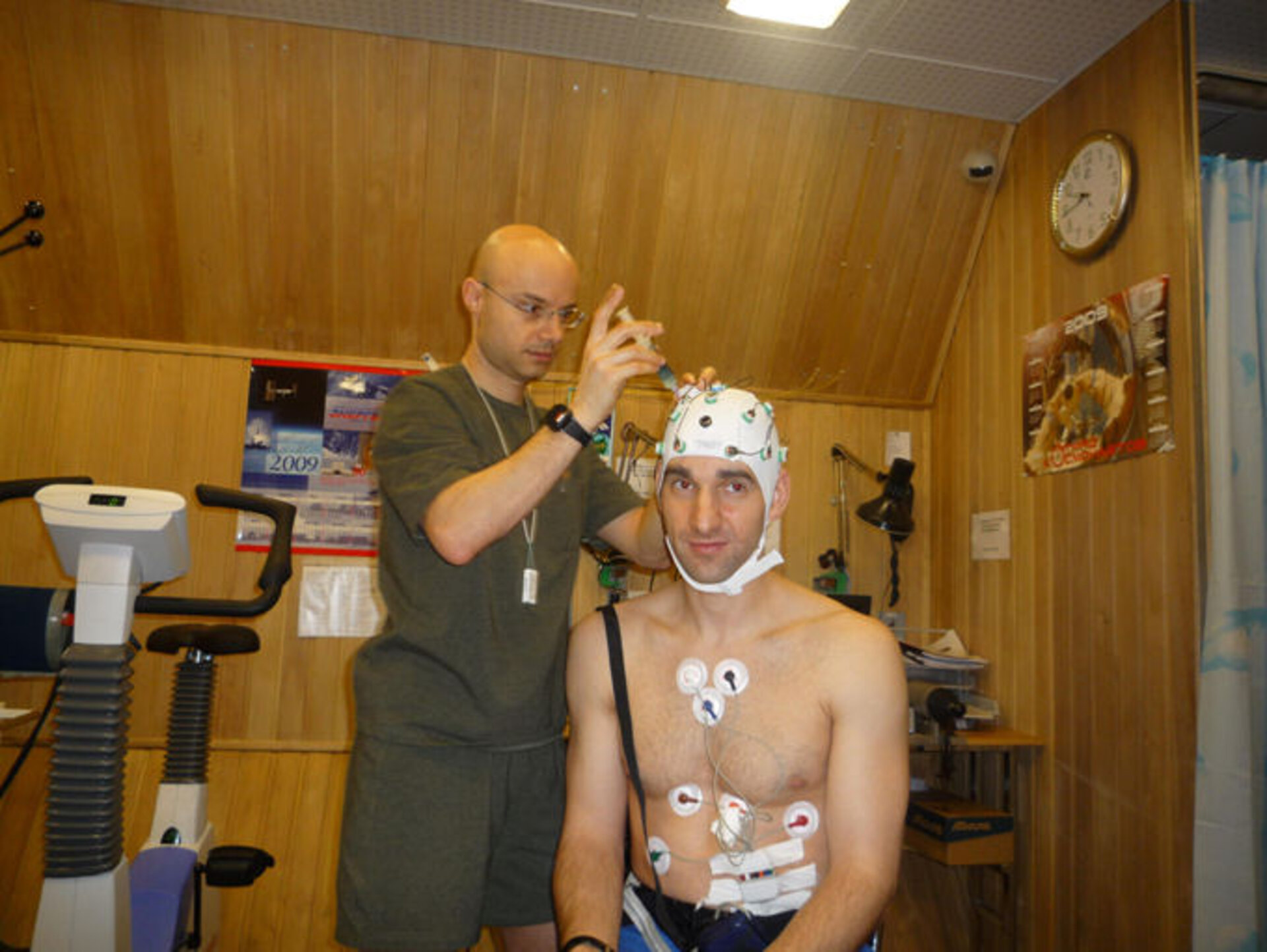 Cyrille preparing Oliver's EEG hat to measure his brainwaves before and after physical training
