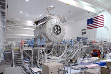 Node 3 is lowered towards a work stand in the Space Station Processing Facility at KSC