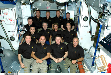The STS-127 and Expedition 20 crewmembers pose for a group portrait