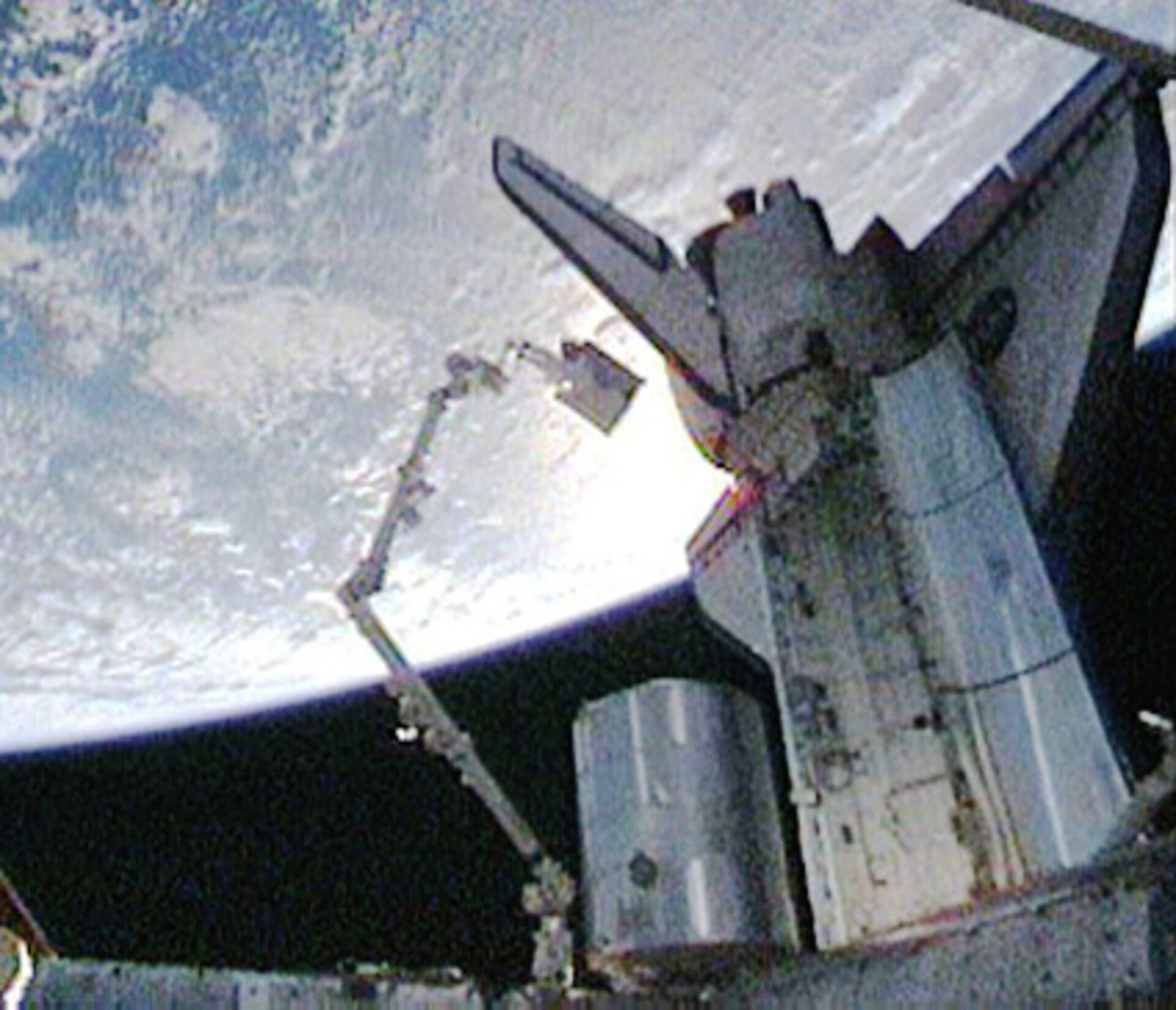 Christer Fuglesang rides the Shuttle robotic arm during the second STS-128 spacewalk