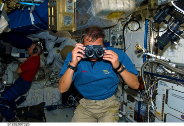 Christer Fuglesang uses a three-dimensional still camera on the ISS