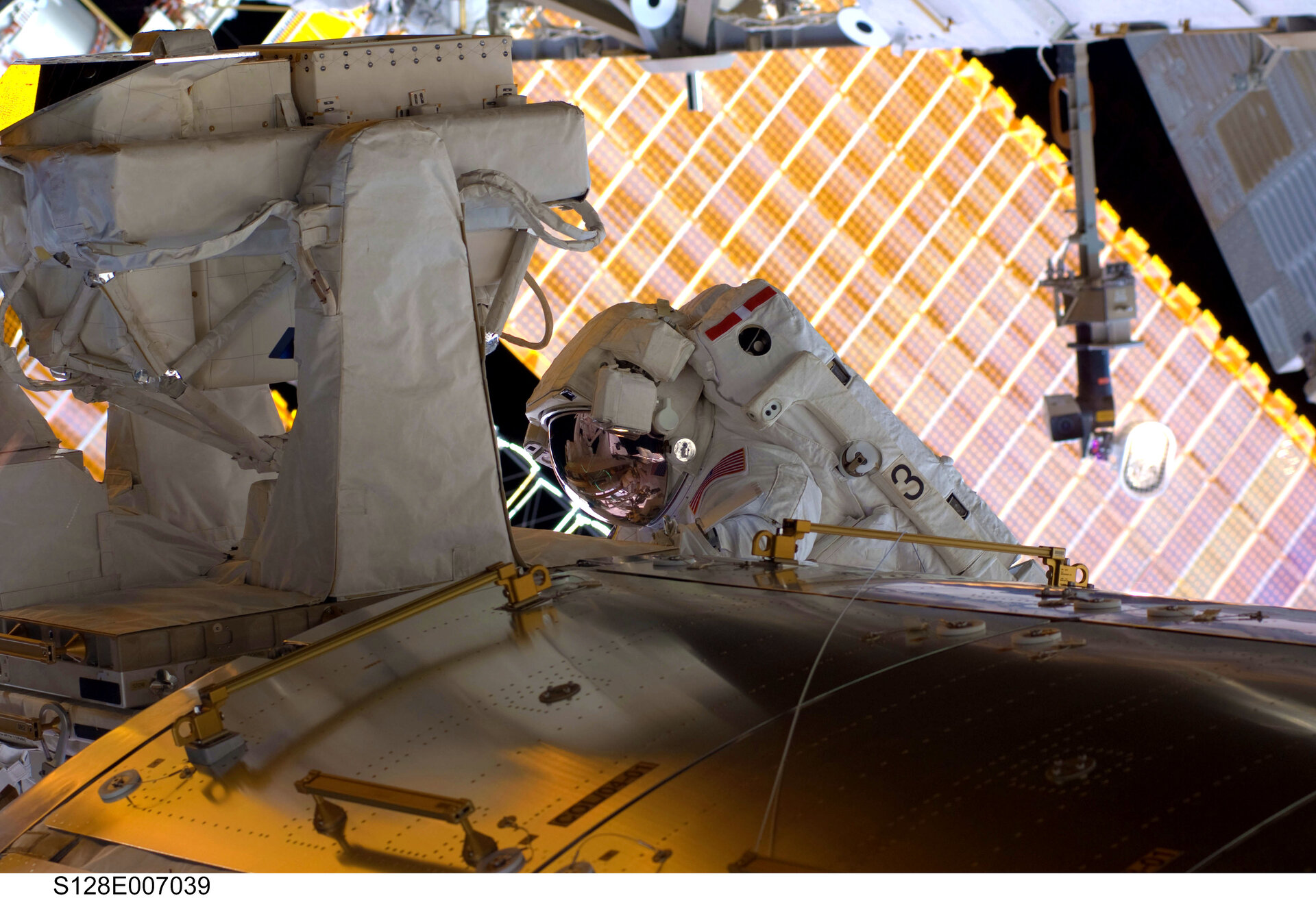 NASA astronaut Nicole Stott works to remove the EuTEF from the outside of Columbus