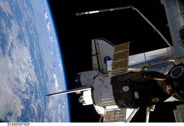 View from the ISS showing Space Shuttle Discovery and a Soyuz spacecraft docked