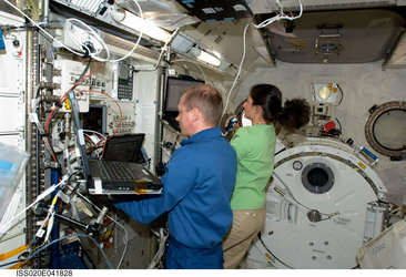 De Winne and Stott work at the controls of the Japanese robotic arm in the Kibo laboratory