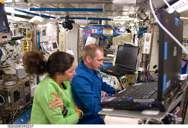 Frank De Winne and Nicole Stott at the controls of the Japanese robotic arm