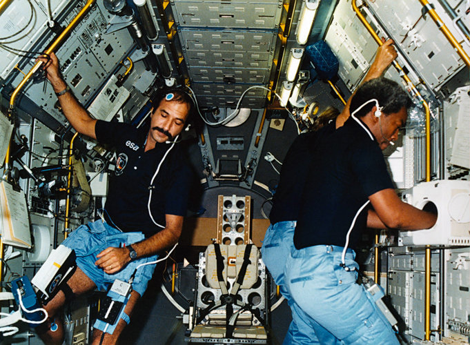 Ockels and Guy Bluford working in Spacelab