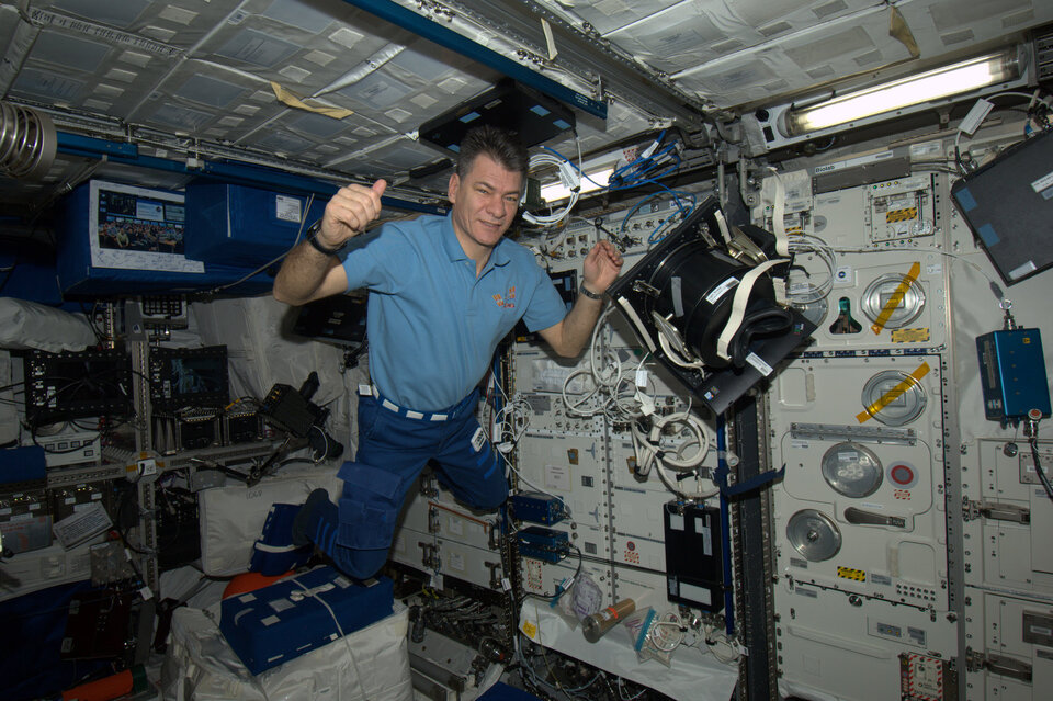ESA astronaut Paolo Nespoli floating in Columbus in front of science racks