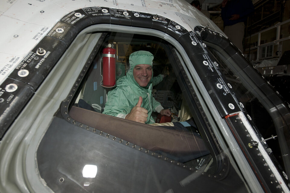 STS-134 Pilot Gregory Johnson inspects the windows on Endeavour