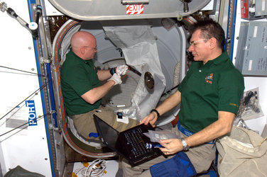 Closing the ISS hatches before Discovery's departure