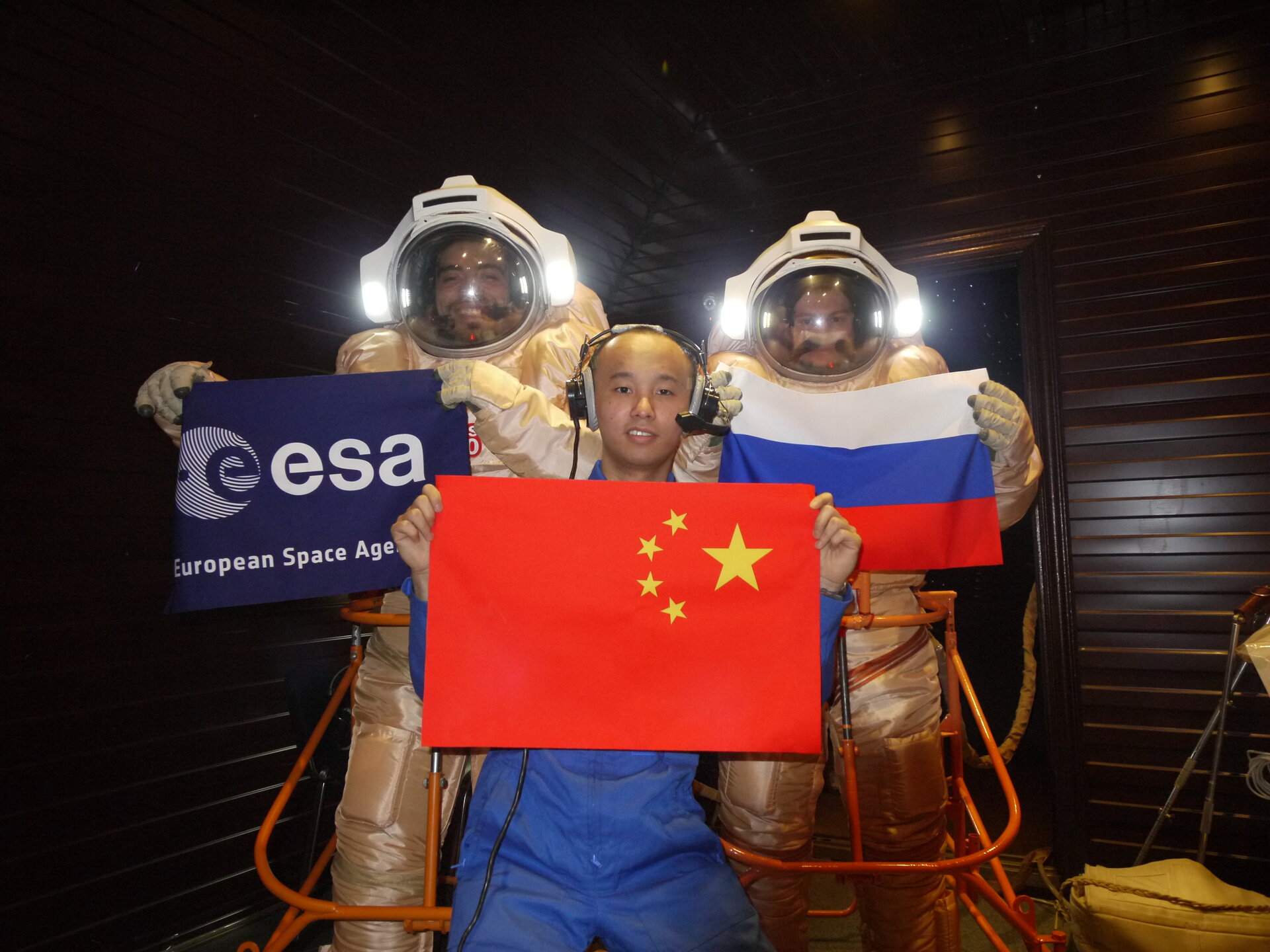 Diego, Alexandr and Wang with flags
