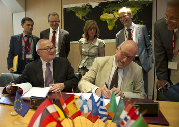 Dordain (left) and Zourek signing the agreement