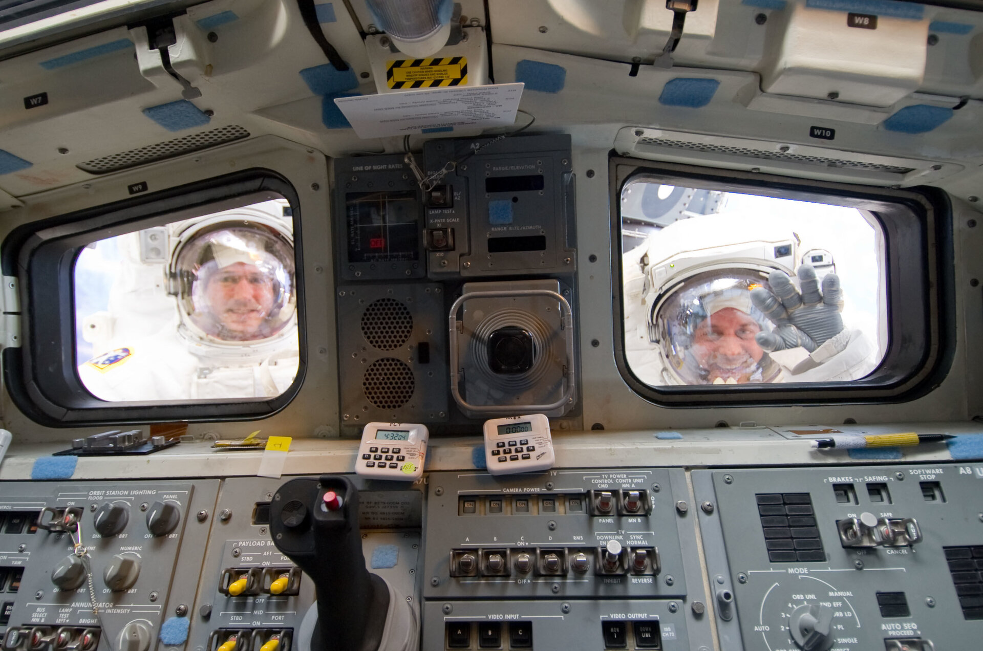 Spacewalkers look through Shuttle's aft flight deck windows