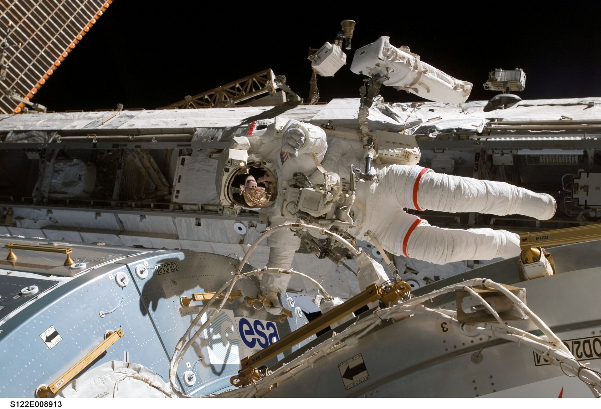 NASA Astronaut Rex Walheim hanging on to Columbus