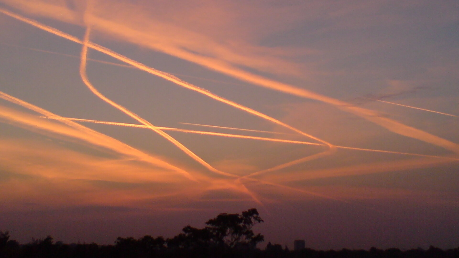 Contrails from air traffic over London's Heathrow Airport