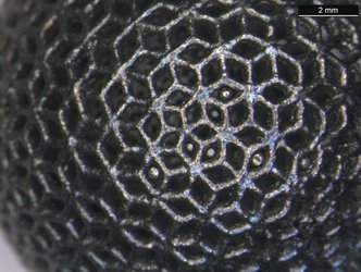 Close-up of 3D-printed titanium lattice ball