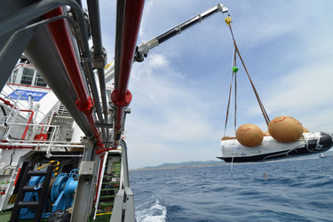 Closeup of IXV prototype being hoisted aboard
