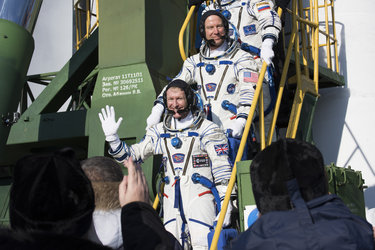 Soyuz TMA-19M crew members greeting audience at the launch pad