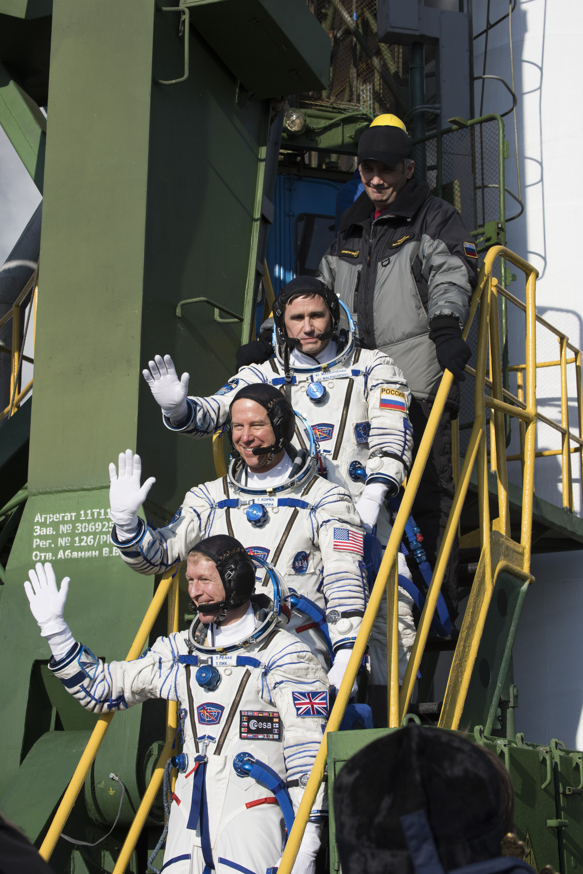 Soyuz TMA-19M crew members greeting audience at the launch pad