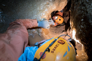 Cavenauts crawl through a tight space during training