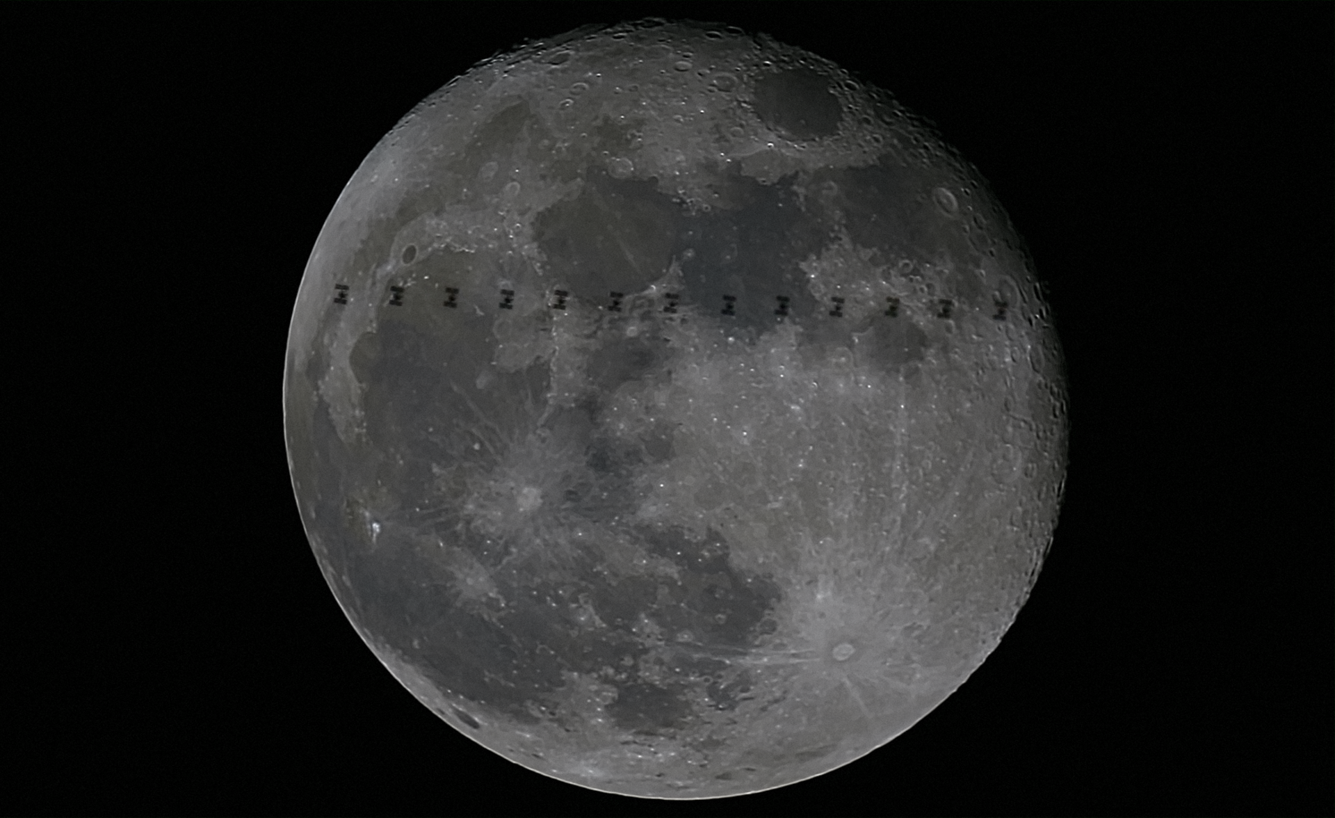 International Space Station flying in front of the Moon