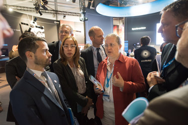 Isabelle Duvaux-Béchon shows AFD representatives the ESA Pavilion