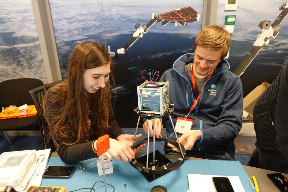 Students performing experiments on their ESAT model during the pilot edition of the ESA Academy’s CubeSat Hands-On Training Week. 