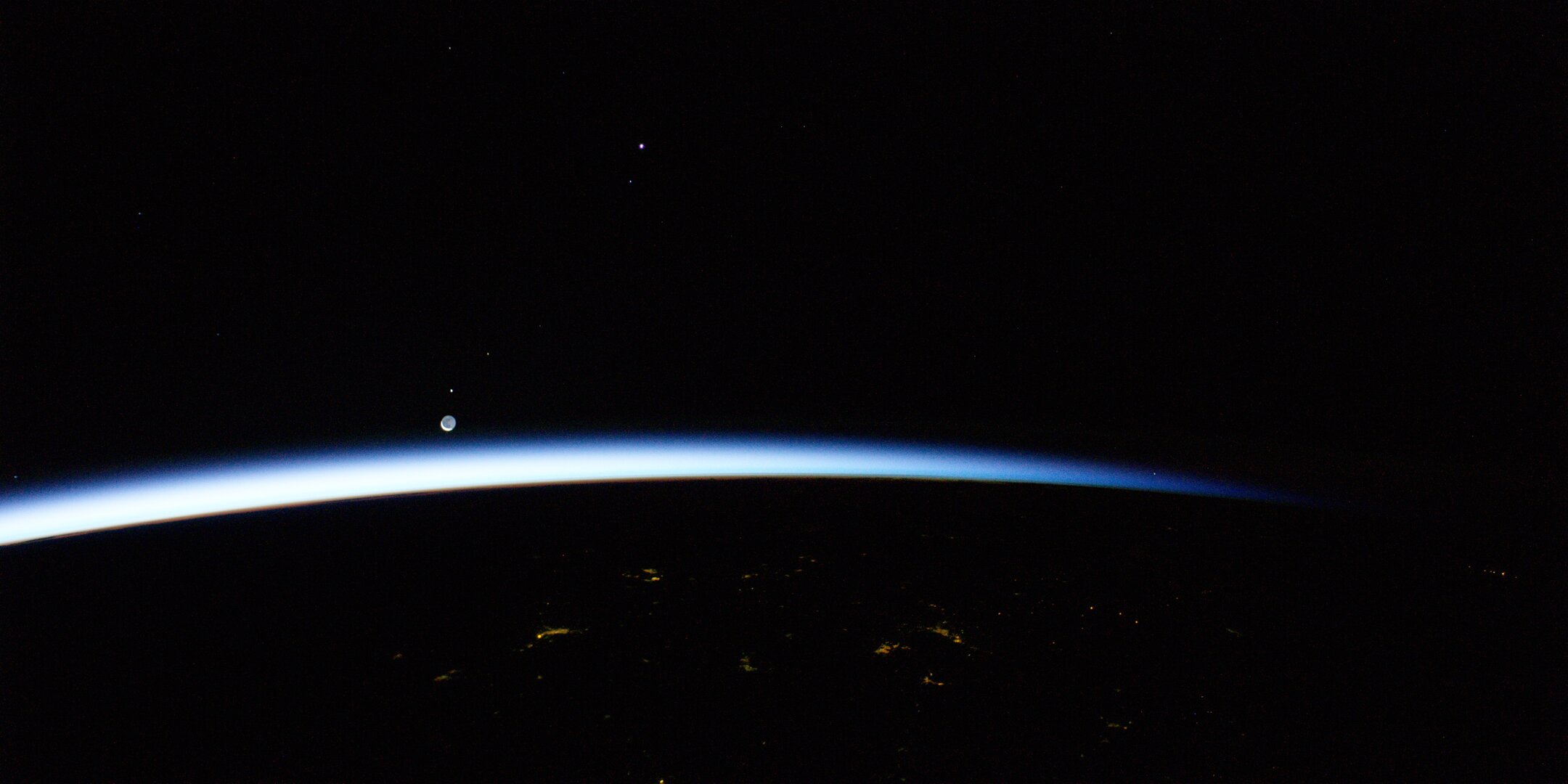 The Moon and Mars rising above Earth seen from the Space Station