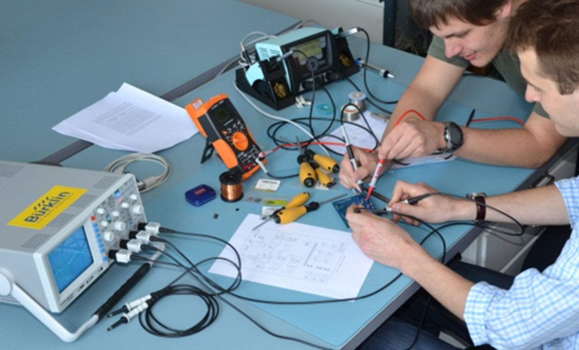 Students perform measurements on electronics hardware